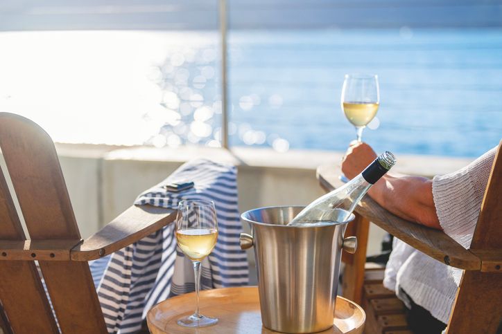 Couple enjoying wine in deck chairs