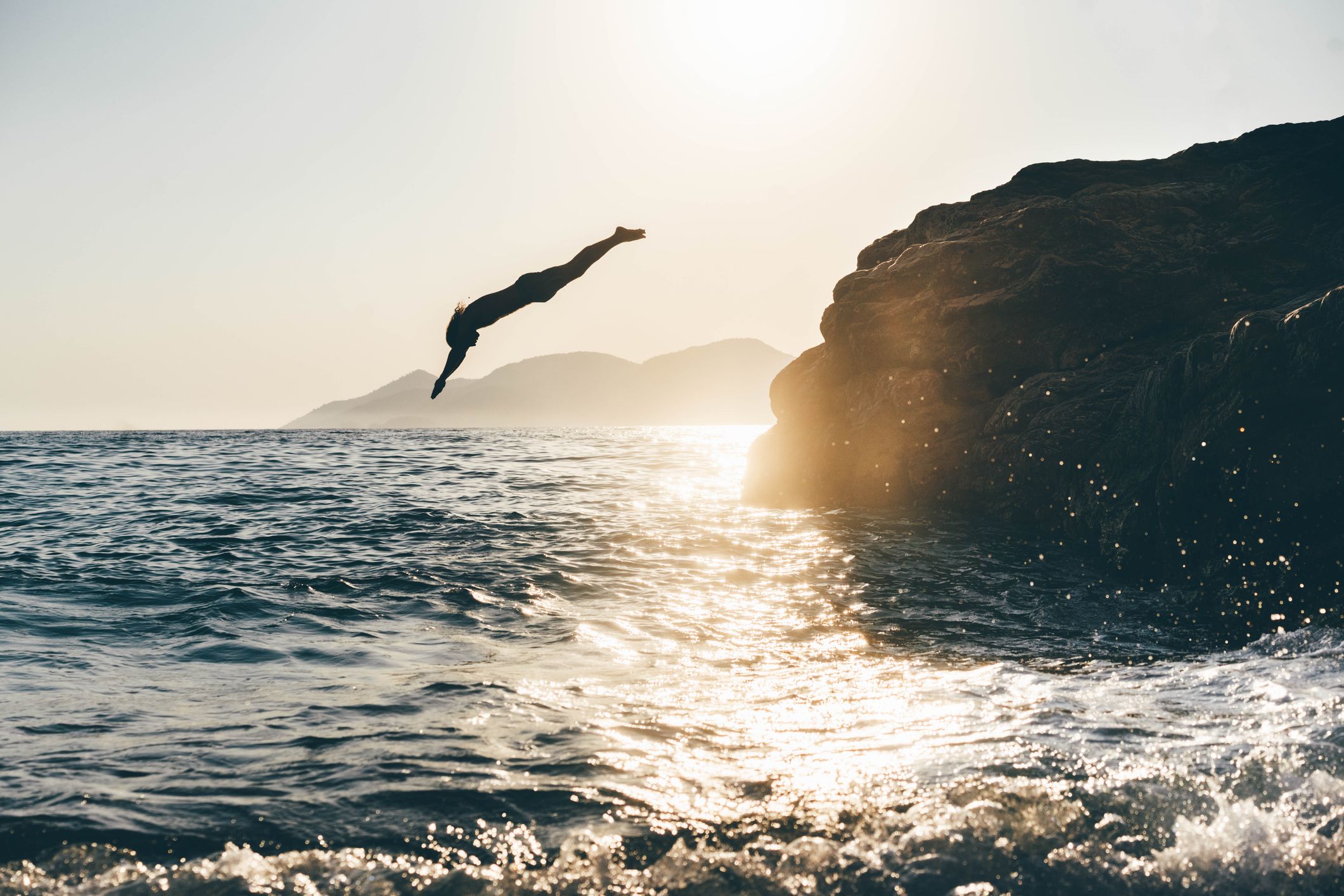 woman diving into ocean