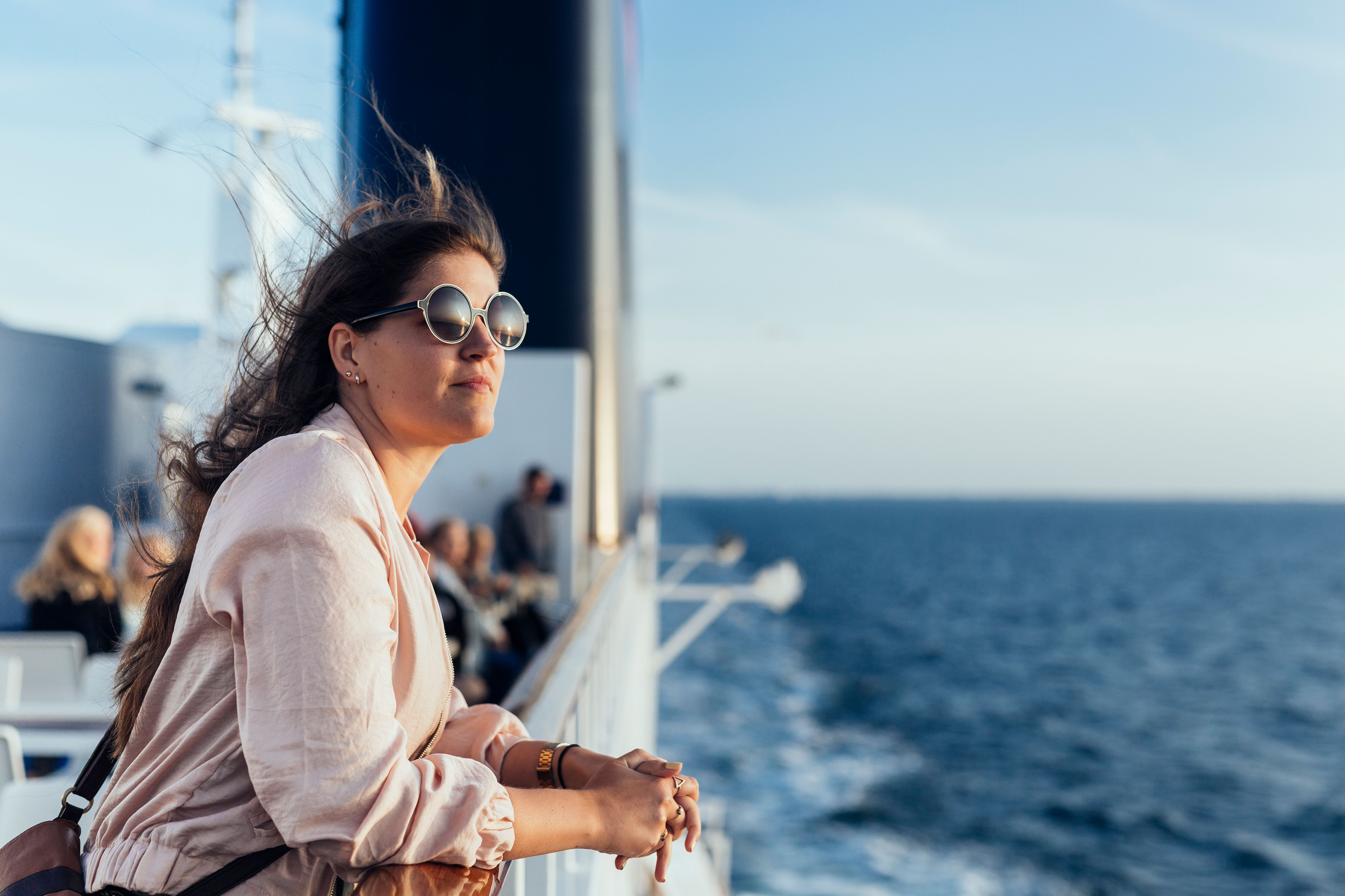 young-woman-leaning-on-railing-on-ship-deck-2024-10-16-15-32-59-utc.jpg